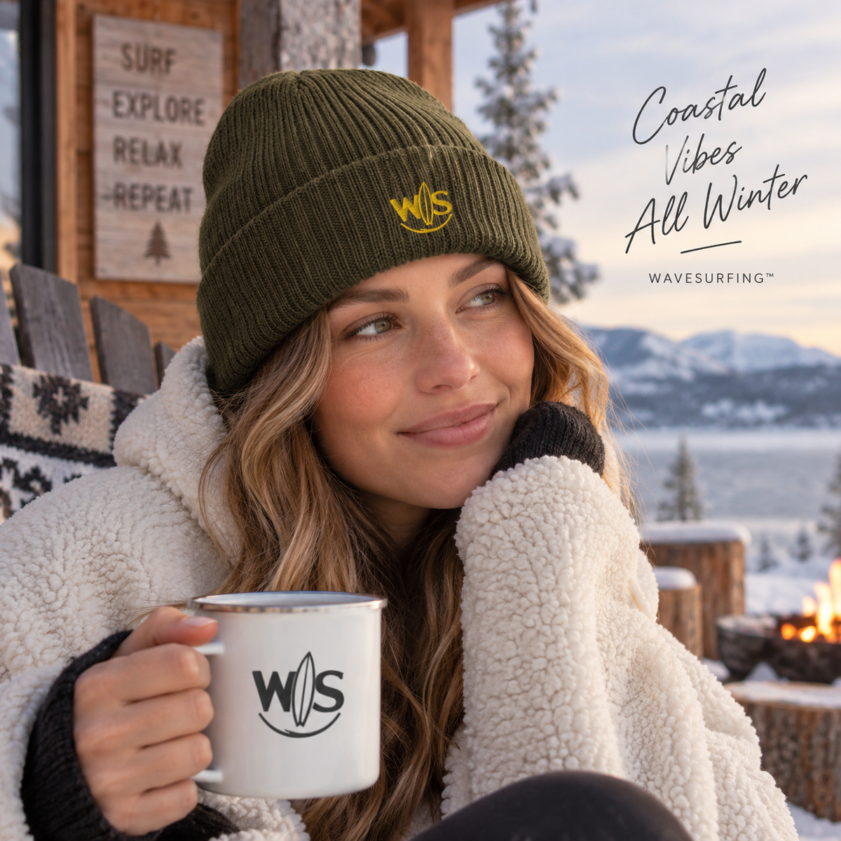 
Woman wearing a WaveSurfing™ olive ribbed knit beanie with embroidered WS logo in a cozy winter mountain setting`
