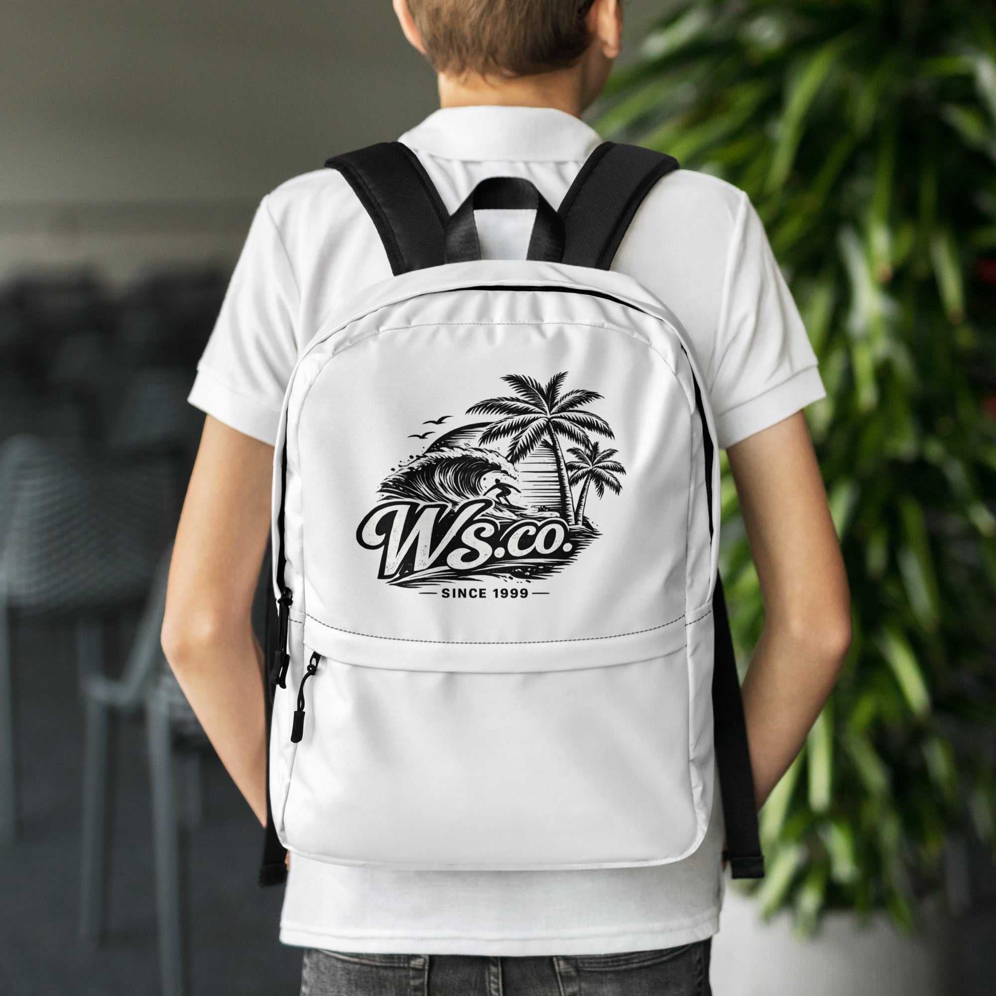 Lifestyle photo of a student walking to school wearing a WaveSurfing™ backpack. Premium surf-style backpack with ergonomic padded straps, a dedicated 15-inch laptop compartment, and water-resistant fabric for daily adventures.